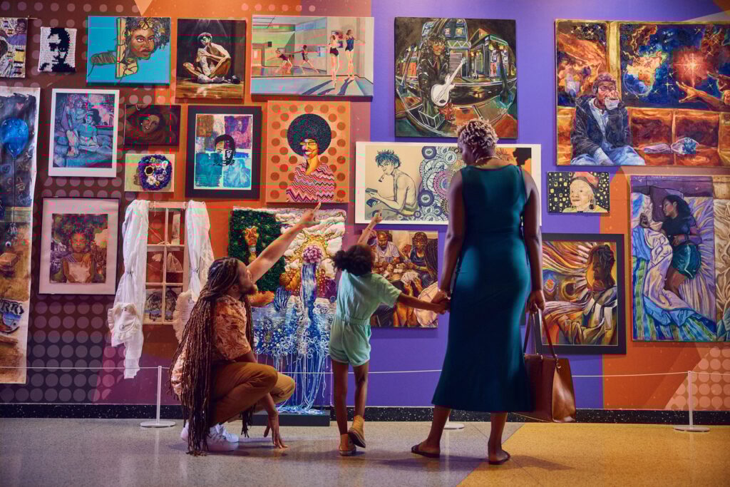 family in front of wall of art