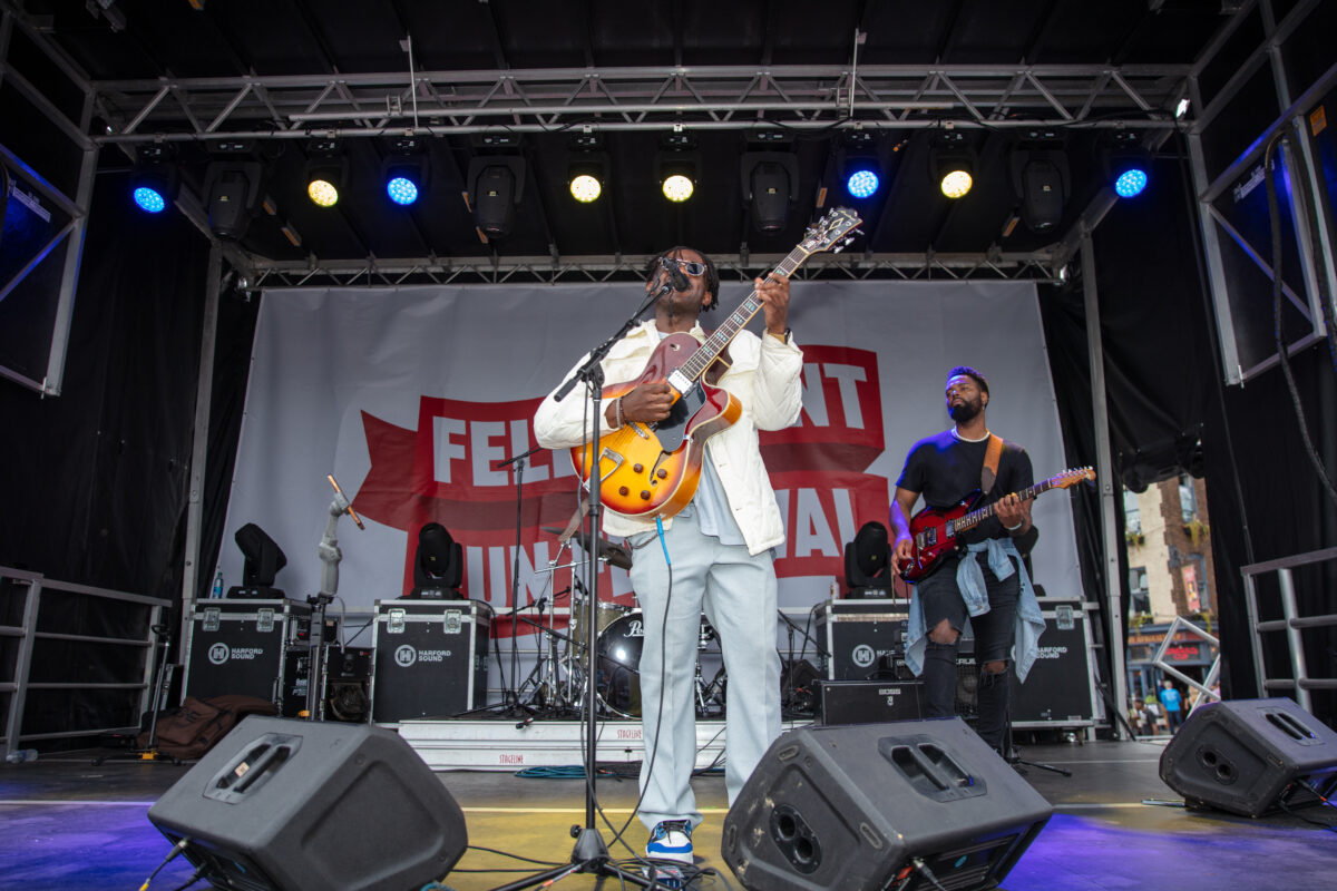 A singer takes center stage with a guitar