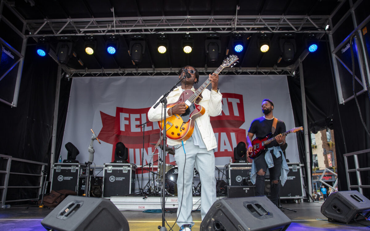 A singer takes center stage with a guitar