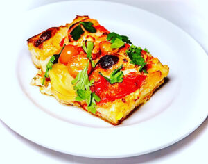 Tomato focaccia bread on a white plate