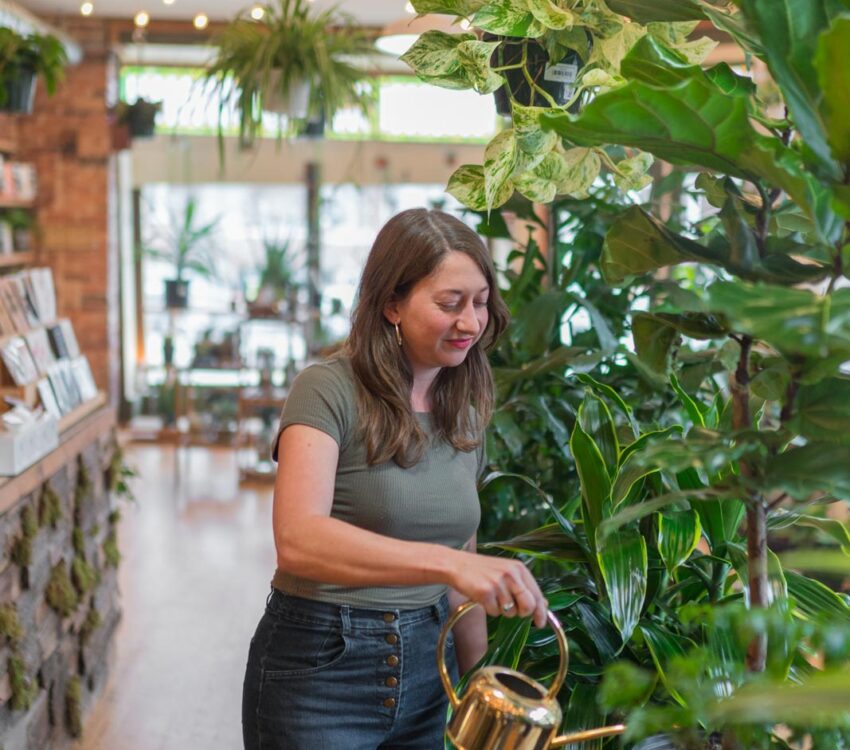 Someone waters plants at B Willow Shop in Baltimore.