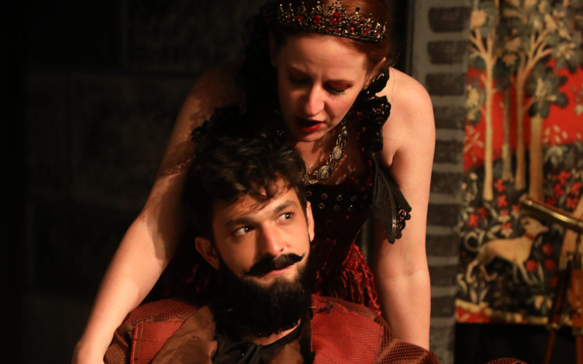 Two actors perform on stage