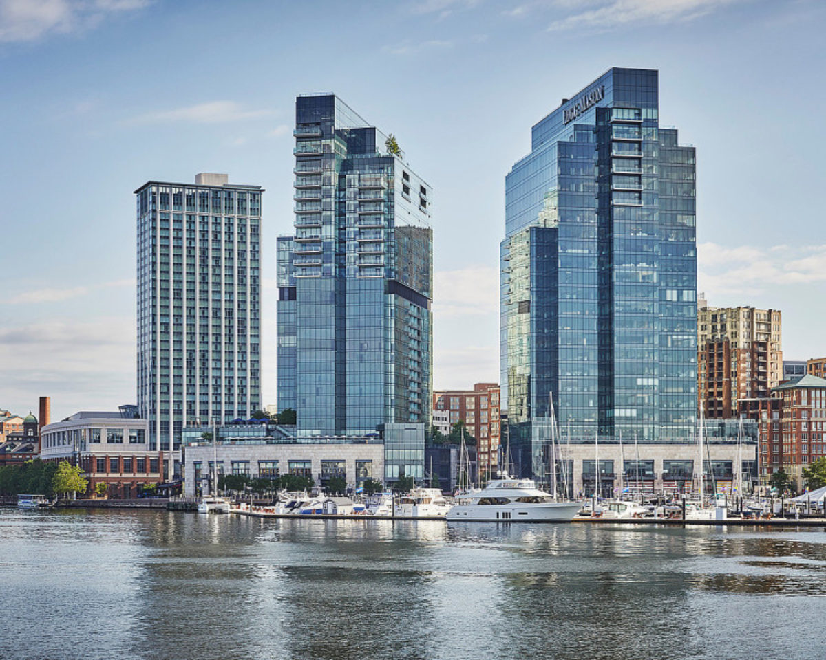 Exterior of the Four Seasons Hotel Baltimore on the harbor on a sunny day.