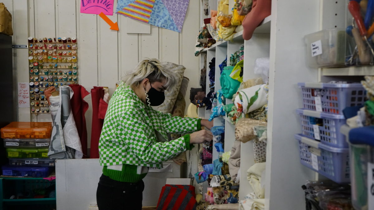 A customer looks for fabric at Scrap Bmore