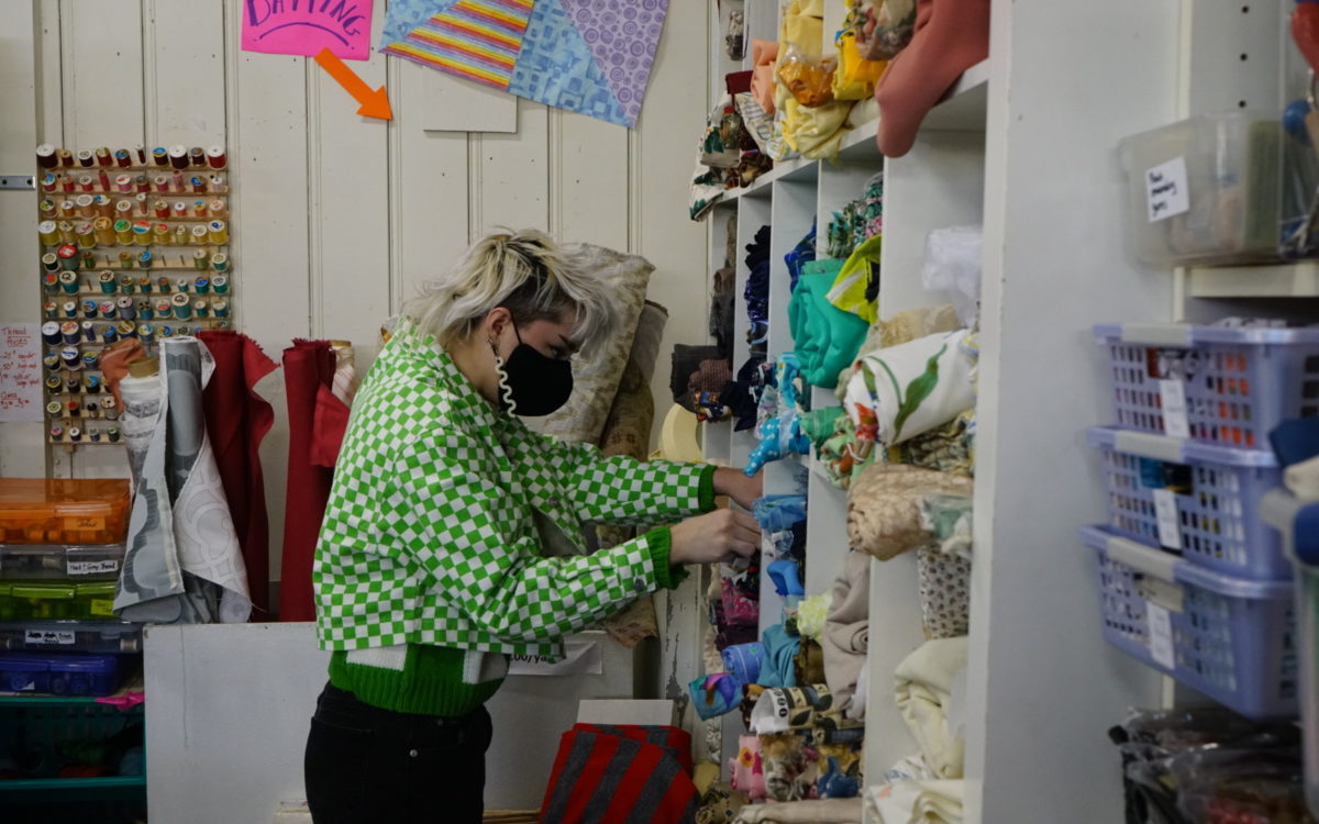 A customer looks for fabric at Scrap Bmore