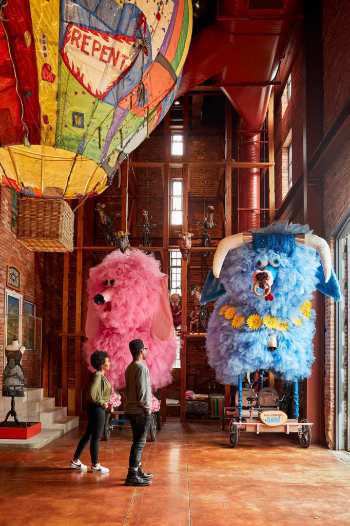 Two people view Fifi Dog sculpture at The American Visionary Art Museum.