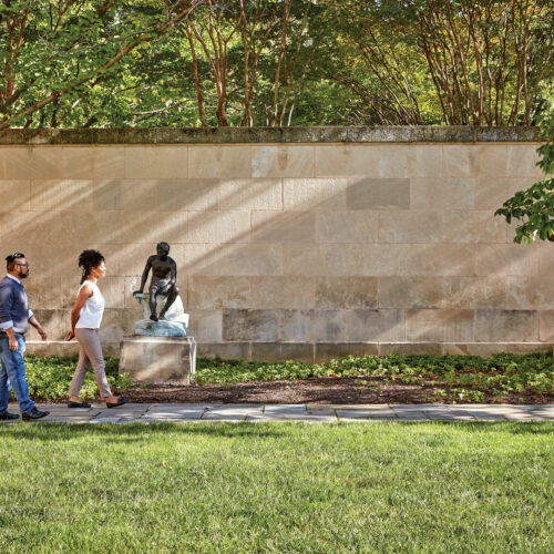 People walking around the outside sculpture garden at The Baltimore Museum of Art.