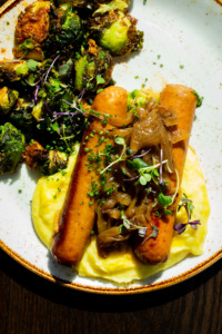 Plate of sausages and Brussels sprouts