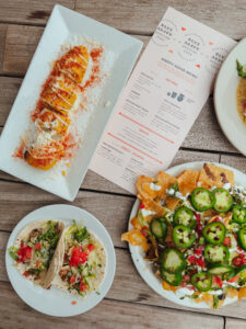 an aerial shot showing a happy hour menu, nachos and tacos