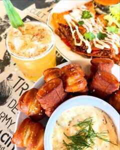 Pretzel bites on a platter and a cocktail
