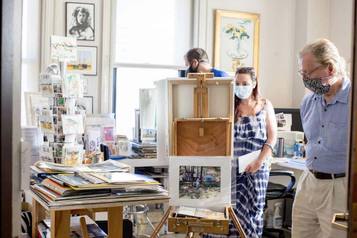 A man and woman admire a canvas in an artists' studio inside Bromo Tower.