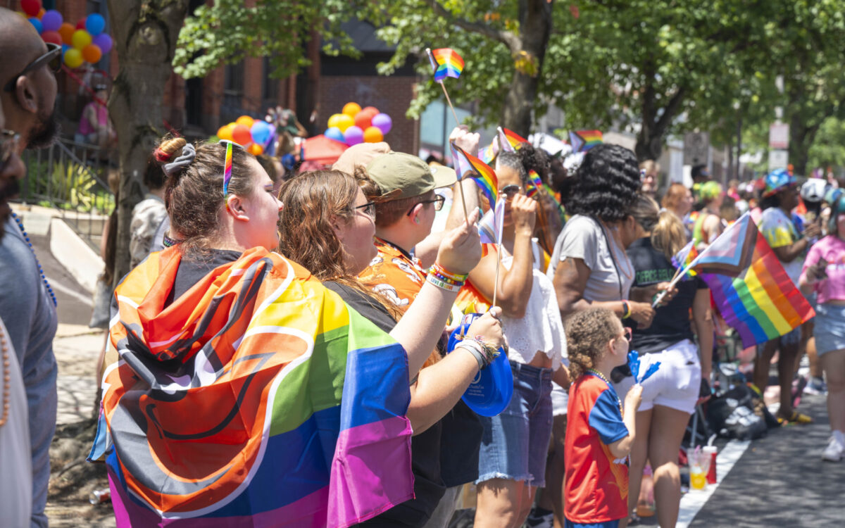 A colorful crowd in rainbow clothing