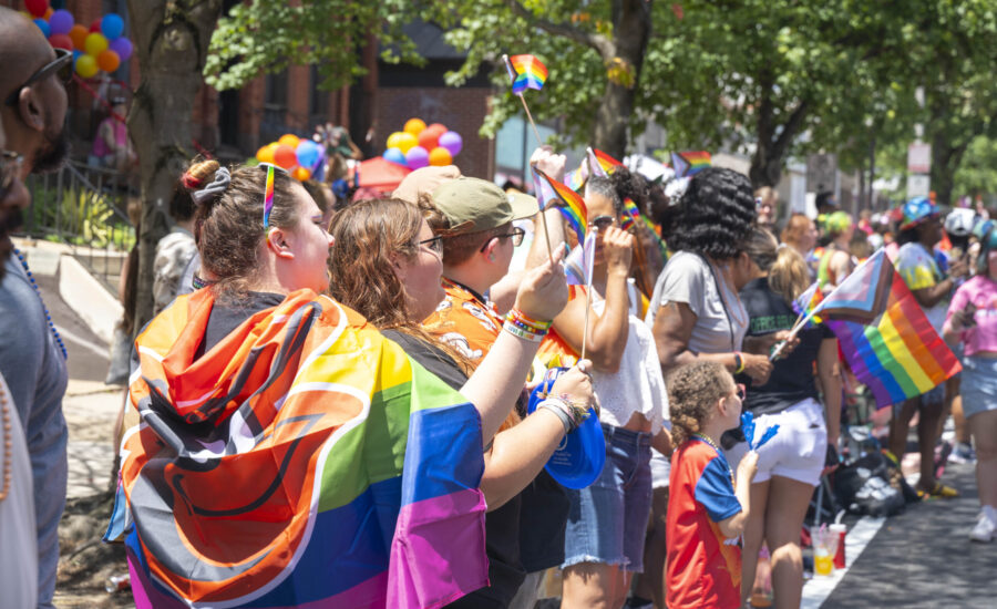 A colorful crowd in rainbow clothing