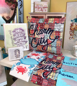 A display of towels and post cards with patterns and designs relating to Baltimore.