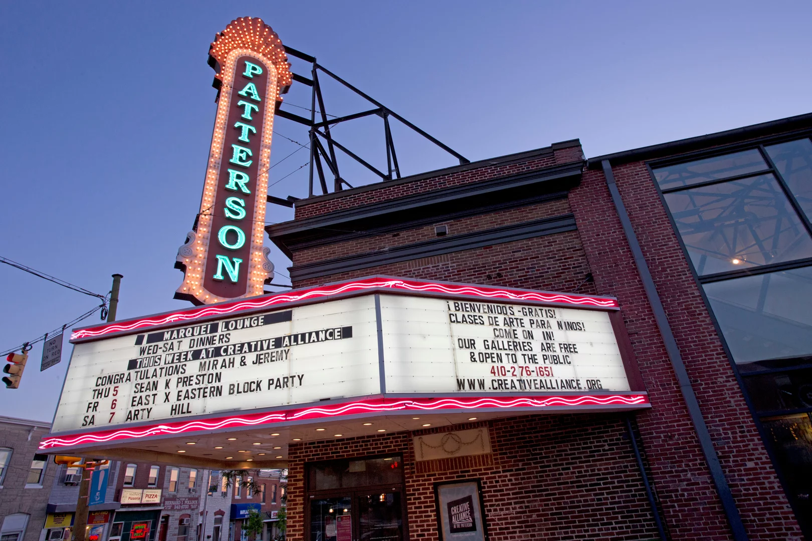 The marquee at Creative Alliance glows under a dusky sky