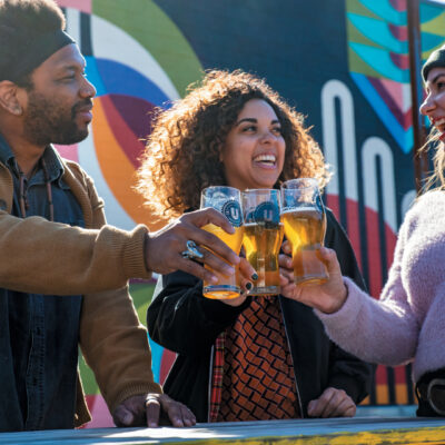 People clinking beer glasses