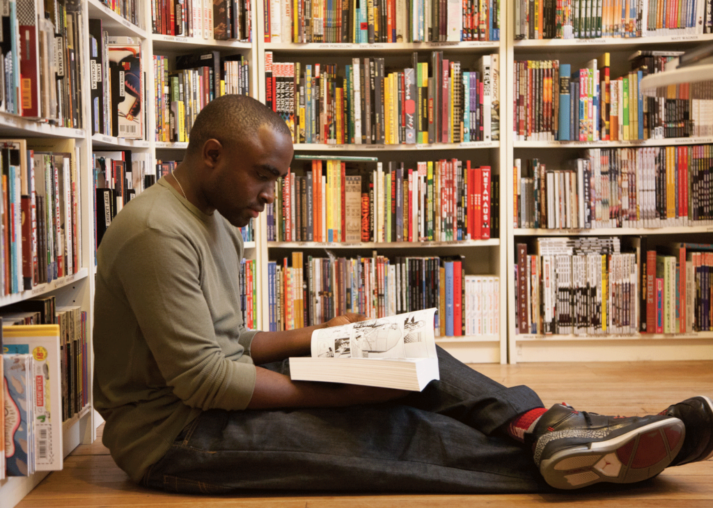 Ken Stanek Man reading in Atomic Books Bookstore.