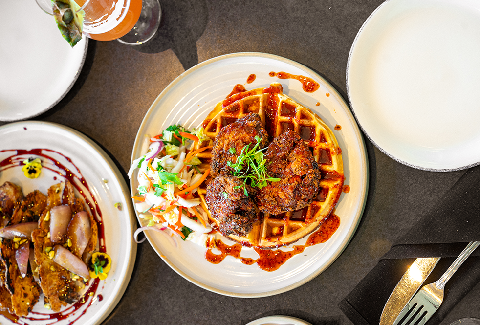 Chicken and waffles on a white plate