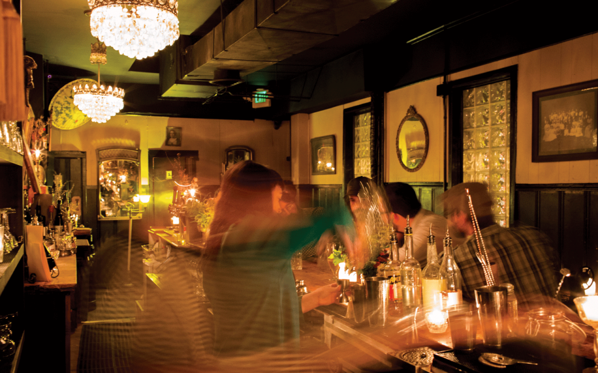 A blurry shot of a bartender making drinks